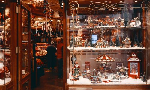 Shop window filled with Christmas villages and holiday decorations