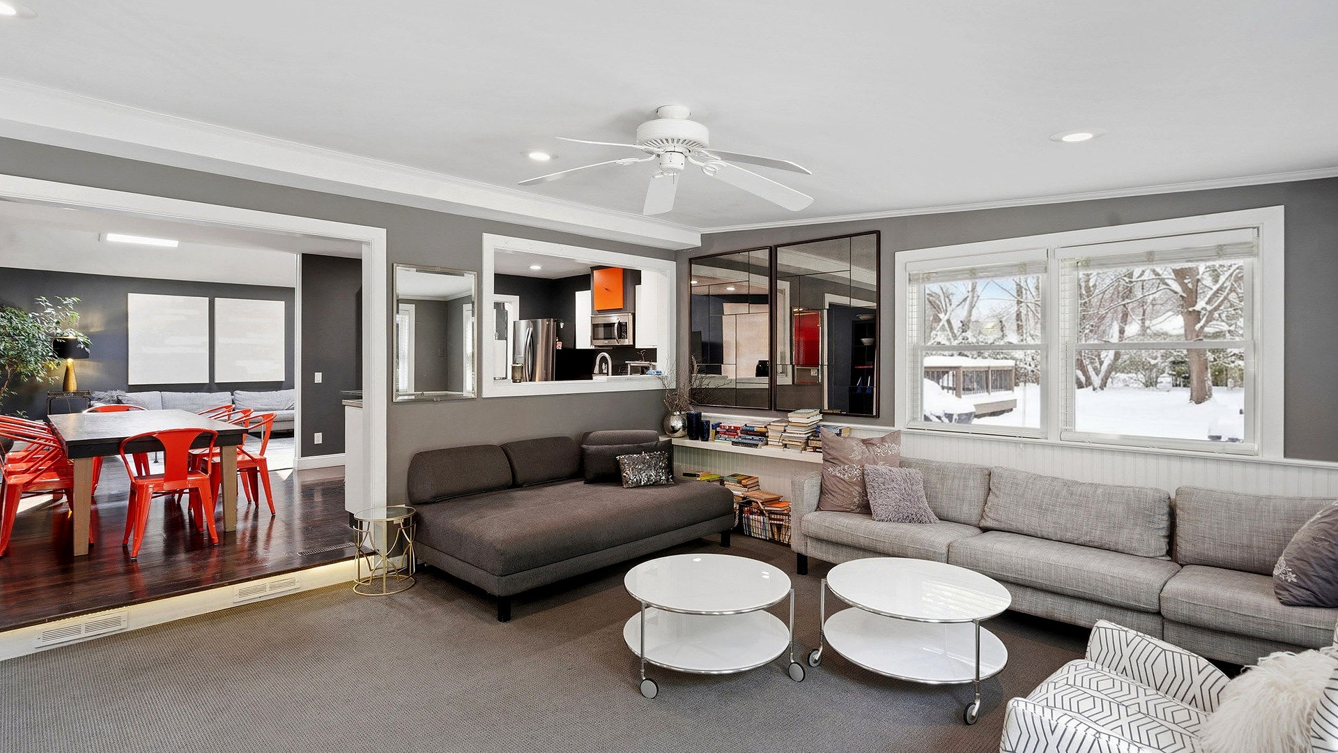 Den and dining area with a snowy yard outside the windows at the Southampton Pool Home Near Village, Southampton, NY