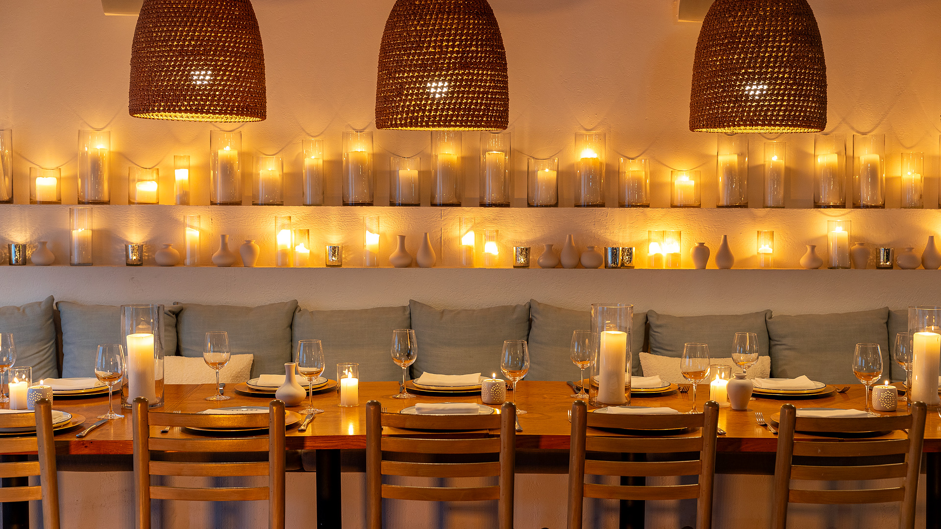 Candlelit dining room with long set tables at Calissa in Water Mill