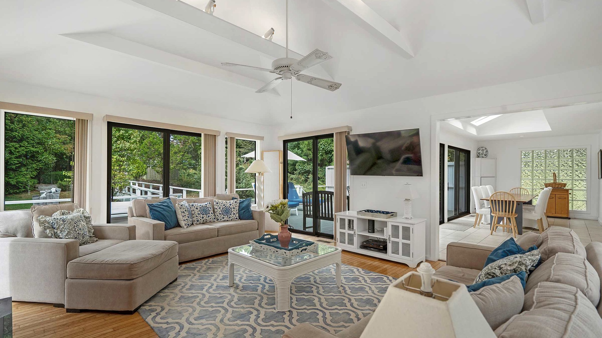 Vaulted living room with sliders to the deck at the Southampton / Shinnecock Retreat in Southampton, NY